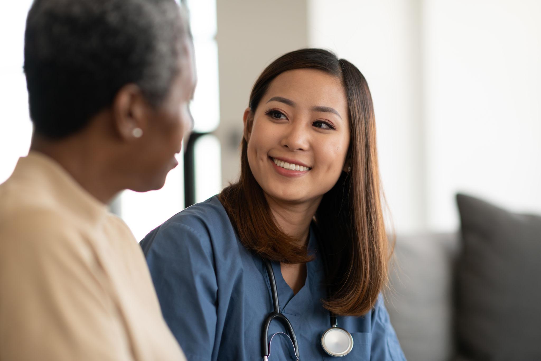 A companion and senior sharing a warm moment together, looking through memories